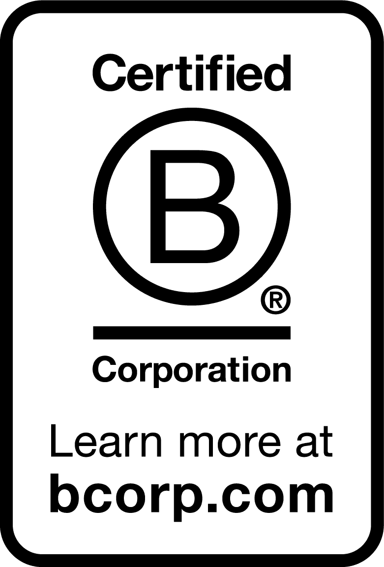 Close-up of a hand holding a glowing, white LED light bulb against a dark, pitch-black background.